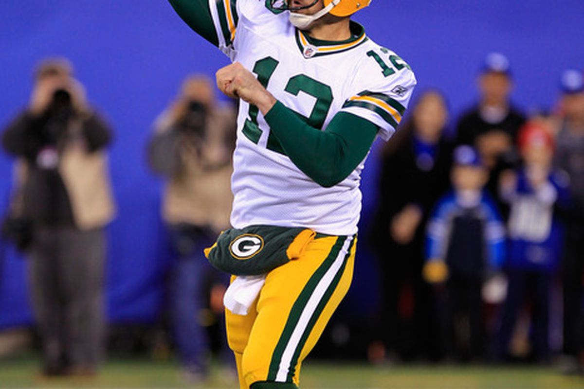 EAST RUTHERFORD, NJ - DECEMBER 04:  Aaron Rodgers #12 of the Green Bay Packers throws a pass against the New York Giants at MetLife Stadium on December 4, 2011 in East Rutherford, New Jersey.  (Photo by Chris Trotman/Getty Images)
