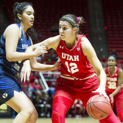 Utah forward Emily Potter (12) drives against Brigham Young forward Shalae Salmon (3) during an NCAA women's college basketball game in Salt Lake City on Saturday, Dec. 10, 2016. Utah defeated rival Brigham Young 77-60.