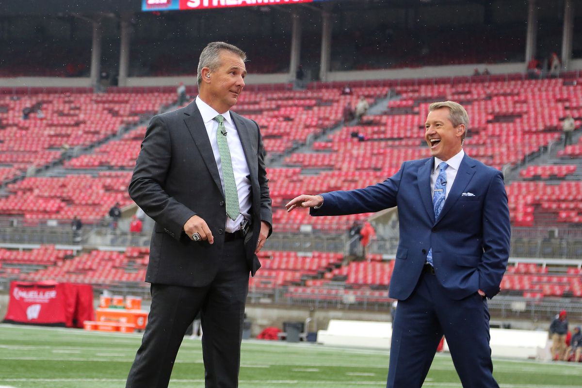 Ohio State Buckeyes former head coach Urban Meyer with Fox broadcaster Rob Stone before the game between the Ohio State Buckeyes and the Wisconsin Badgers at Ohio Stadium.