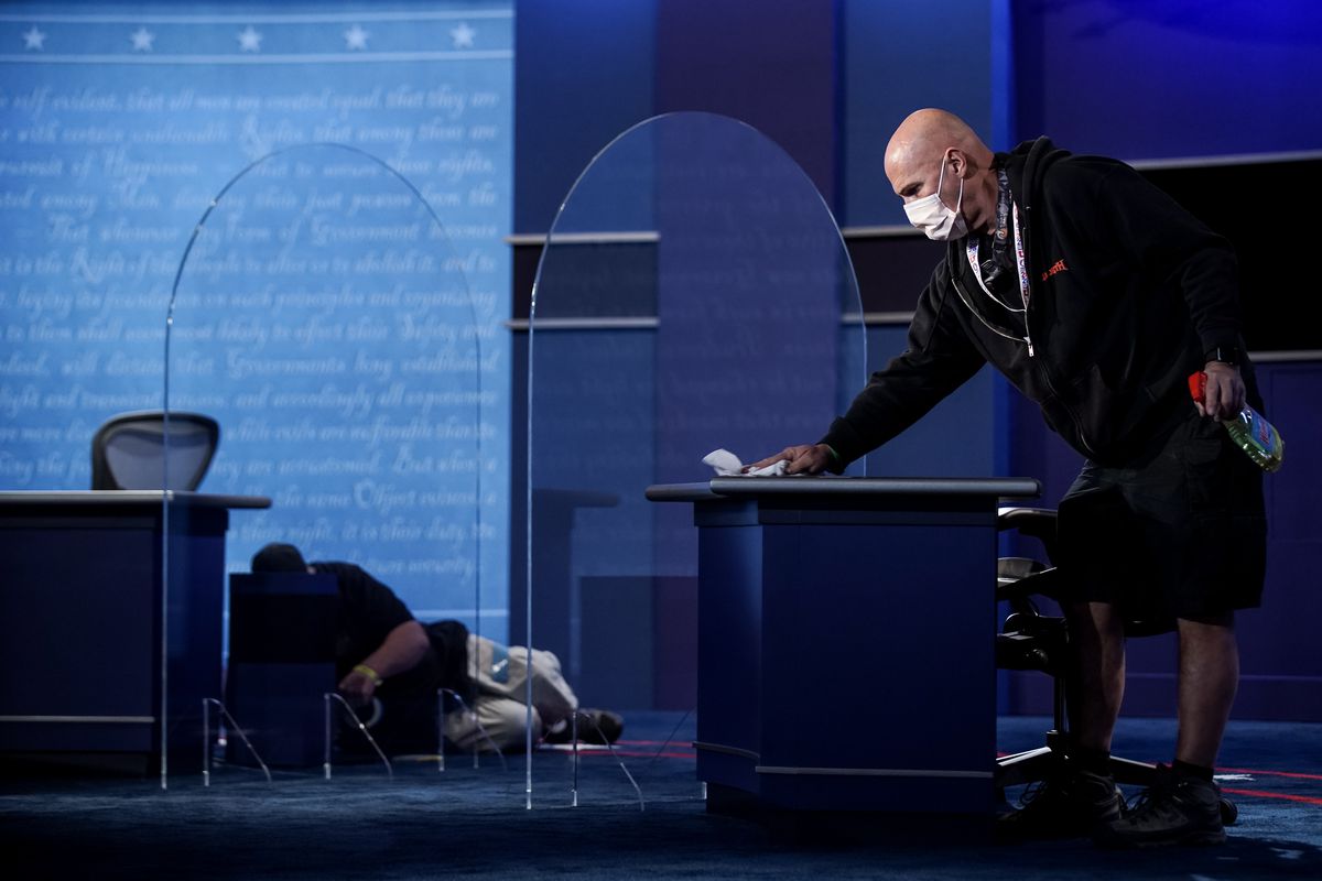 Crew members put the final touches on the stage, which now includes plexiglass partitions, at Kingsbury Hall at the University of Utah in Salt Lake City on Tuesday, Oct. 6, 2020, in preparation for Wednesday’s vice presidential debate.