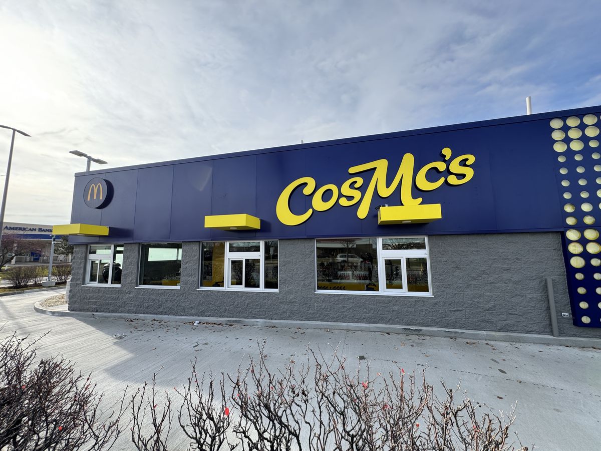 The dark blue and yellow facade on CosMc’s drive-thru windows. 