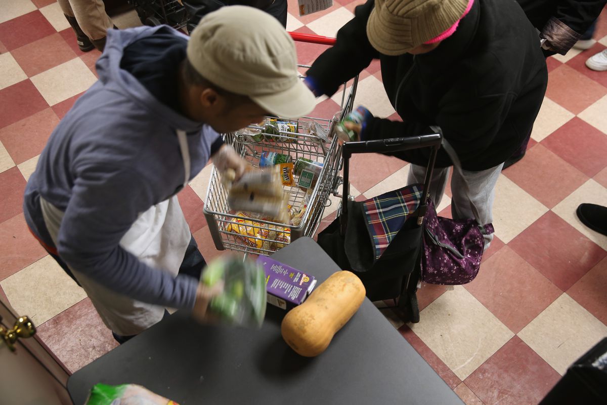 Harlem residents pack free groceries at the Food Bank For New York City on December 11, 2013.