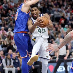 Utah Jazz guard Donovan Mitchell (45) moves around New York Knicks center Enes Kanter (00) during a basketball game at the Vivint Smart Home Arena in Salt Lake City on Friday, Jan. 19, 2018.