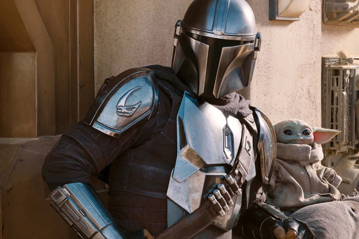 The Mandalorian and Baby Yoda stand together in a still shot from The Mandalorian season 2.