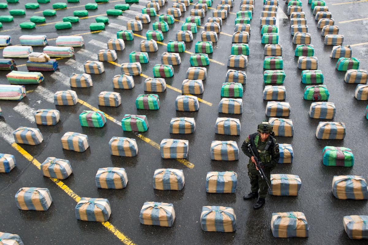 A soldier stands by seized drugs in Colombia.