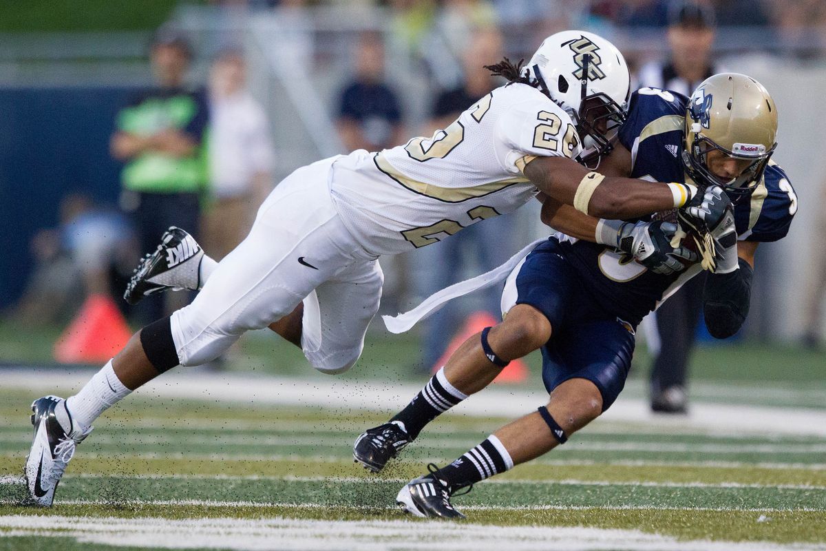 Aug 30, 2012; Akron, OH, USA; Akron Zips wide receiver LT Smith (3) gets hit by Central Florida Knights defensive back Clayton Geathers (26) after his catch at InfoCision Stadium. Mandatory Credit: Rob Leifheit-US PRESSWIRE