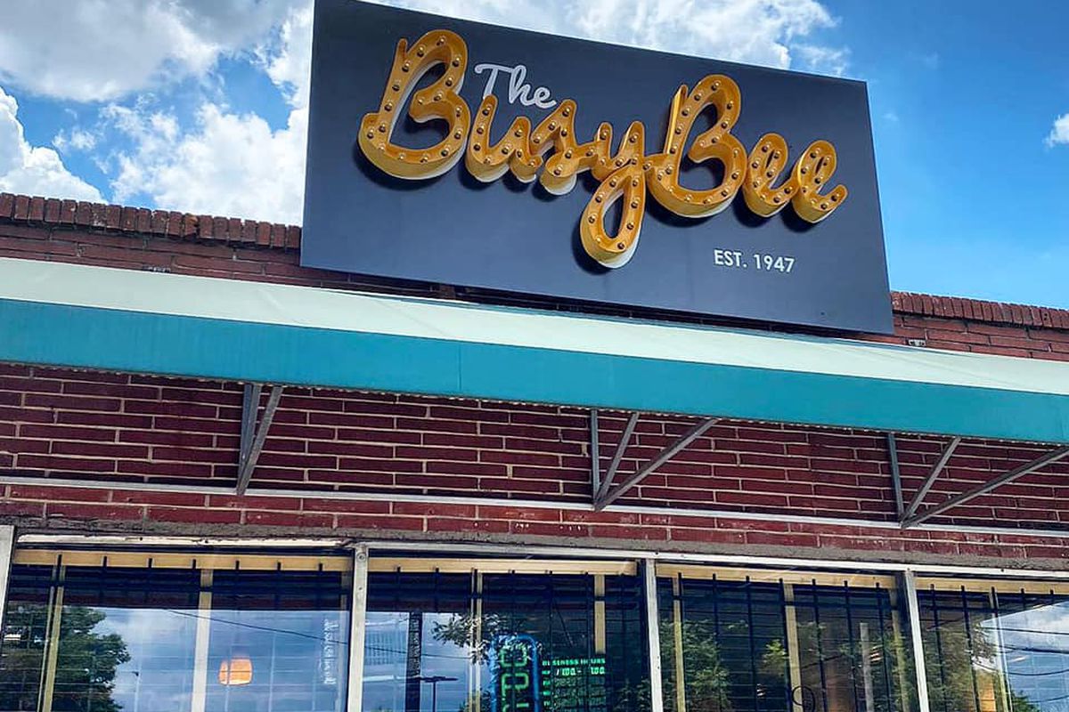 The outside neon yellow signage for Busy Bee Cafe in Atlanta, GA.