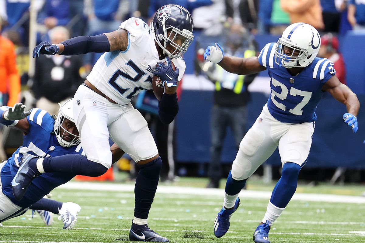 Derrick Henry #22 of the Tennessee Titans carries the ball against Xavier Rhodes #27 of the Indianapolis Colts in the second half at Lucas Oil Stadium on October 31, 2021 in Indianapolis, Indiana.