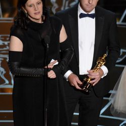 Laura Poitras, left, and Glenn Greenwald accept the award for best documentary feature for “Citizenfour” at the Oscars on Sunday, Feb. 22, 2015, at the Dolby Theatre in Los Angeles. 