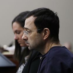 Dr. Larry Nassar is seated during the seventh day of his sentencing hearing Wednesday, Jan. 24, 2018, in Lansing, Mich. Nassar has admitted sexually assaulting athletes when he was employed by Michigan State University and USA Gymnastics, which is the sport's national governing organization and trains Olympians. (AP Photo/Carlos Osorio)