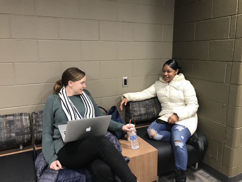 Katherine “Kat” Grow, the alumni success coordinator at the Jalen Rose Leadership Academy, chats with Kashia Perkins, an alum of the school now in her freshman year at Michigan State University.