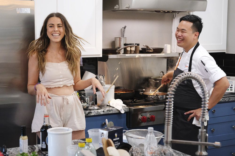 Chef Buddha Lo and his wife Rebekah Pedler laugh together while in the kitchen.