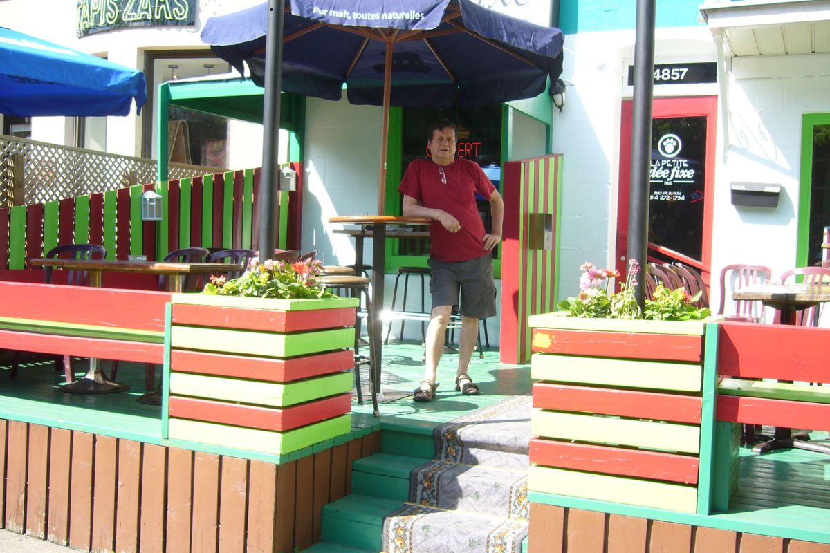 man standing in front of bar