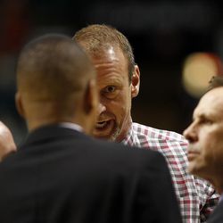 Utah Utes head coach Larry Krystkowiak, center, talks with his coaches during the Pac-12 conference tournament semifinal against the Cal Bears at the MGM Grand Garden Arena in Las Vegas, Friday, March 11, 2016.