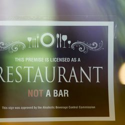 A restaurant sign approved by the Alcoholic Beverage Control Commission is posted at Takashi in Salt Lake City on Tuesday, May 9, 2017.