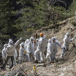 In this photo provided Friday, April 3, 2015 by the French Interior Ministry, French emergency rescue services work among debris of the Germanwings passenger jet at the crash site near Seyne-les-Alpes, France. The co-pilot of the doomed Germanwings flight repeatedly sped up the plane as he used the automatic pilot to descend the A320 into the Alps, the French air accident investigation agency said Friday. 