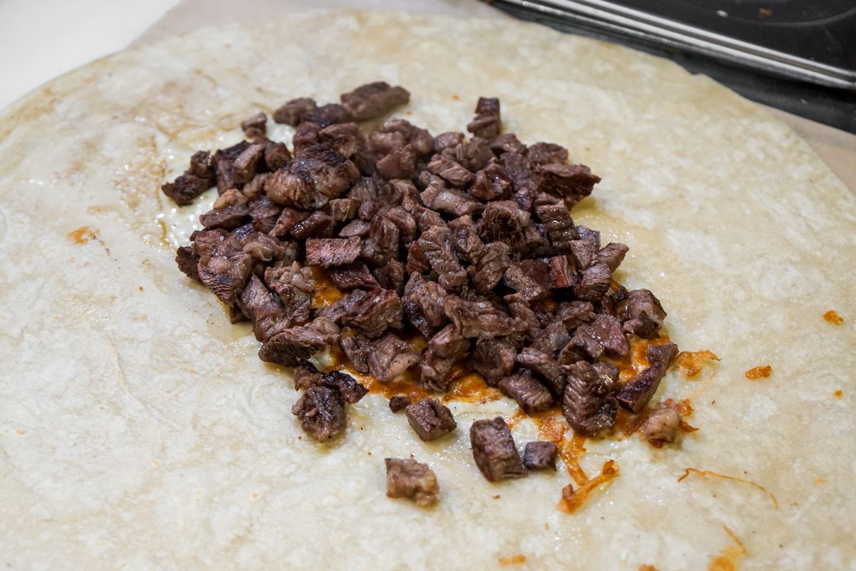 Chopped beef with griddled cheese in a flour tortilla.