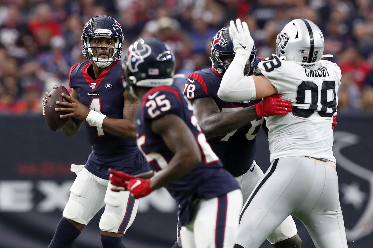 Deshaun Watson of the Houston Texans looks to pass as Laremy Tunsil blocks Maxx Crosby of the Oakland Raiders in the second half at NRG Stadium on October 27, 2019 in Houston, Texas.