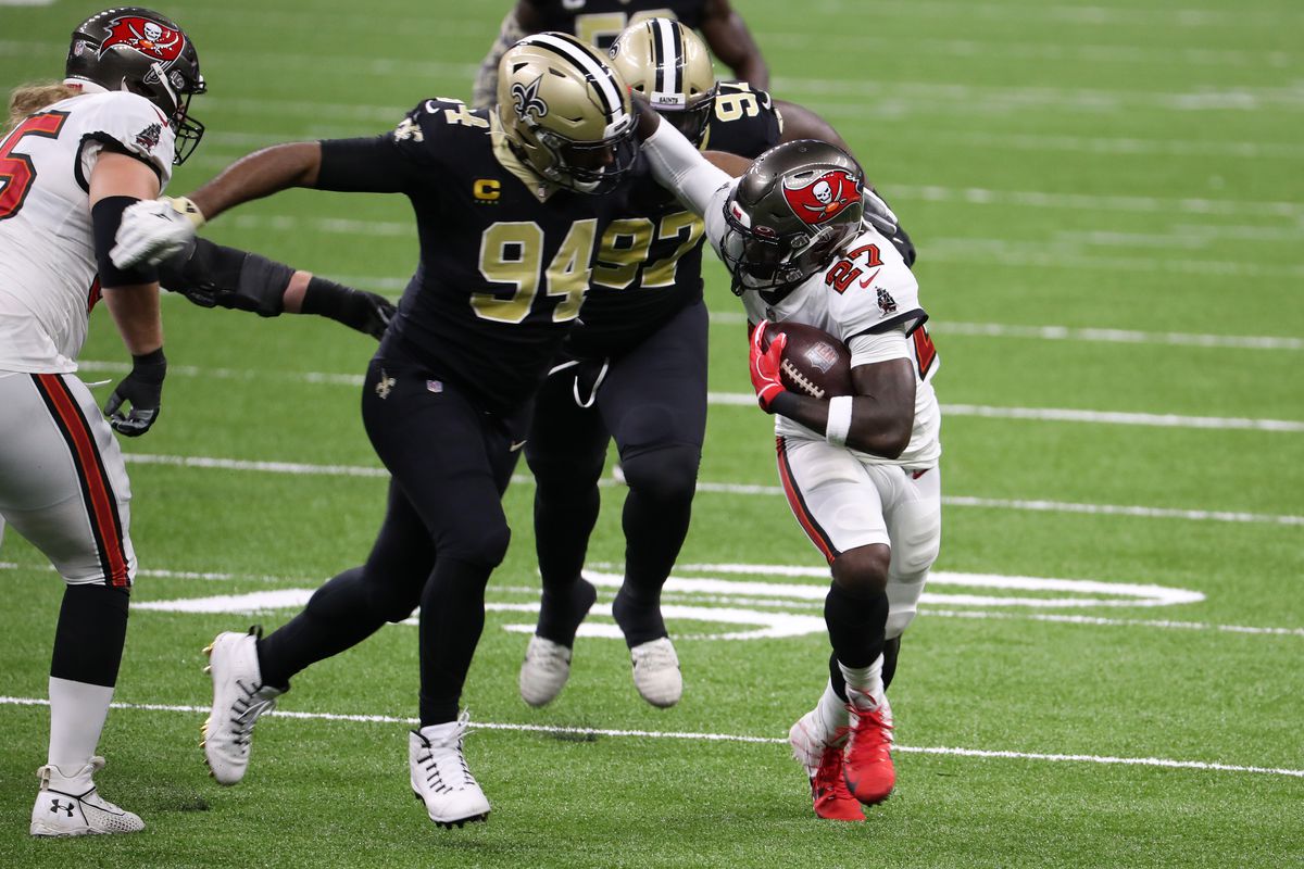 Ronald Jones of the Tampa Bay Buccaneers is tackled by Cameron Jordan of the New Orleans Saints during the first quarter at Mercedes-Benz Superdome on September 13, 2020 in New Orleans, Louisiana.