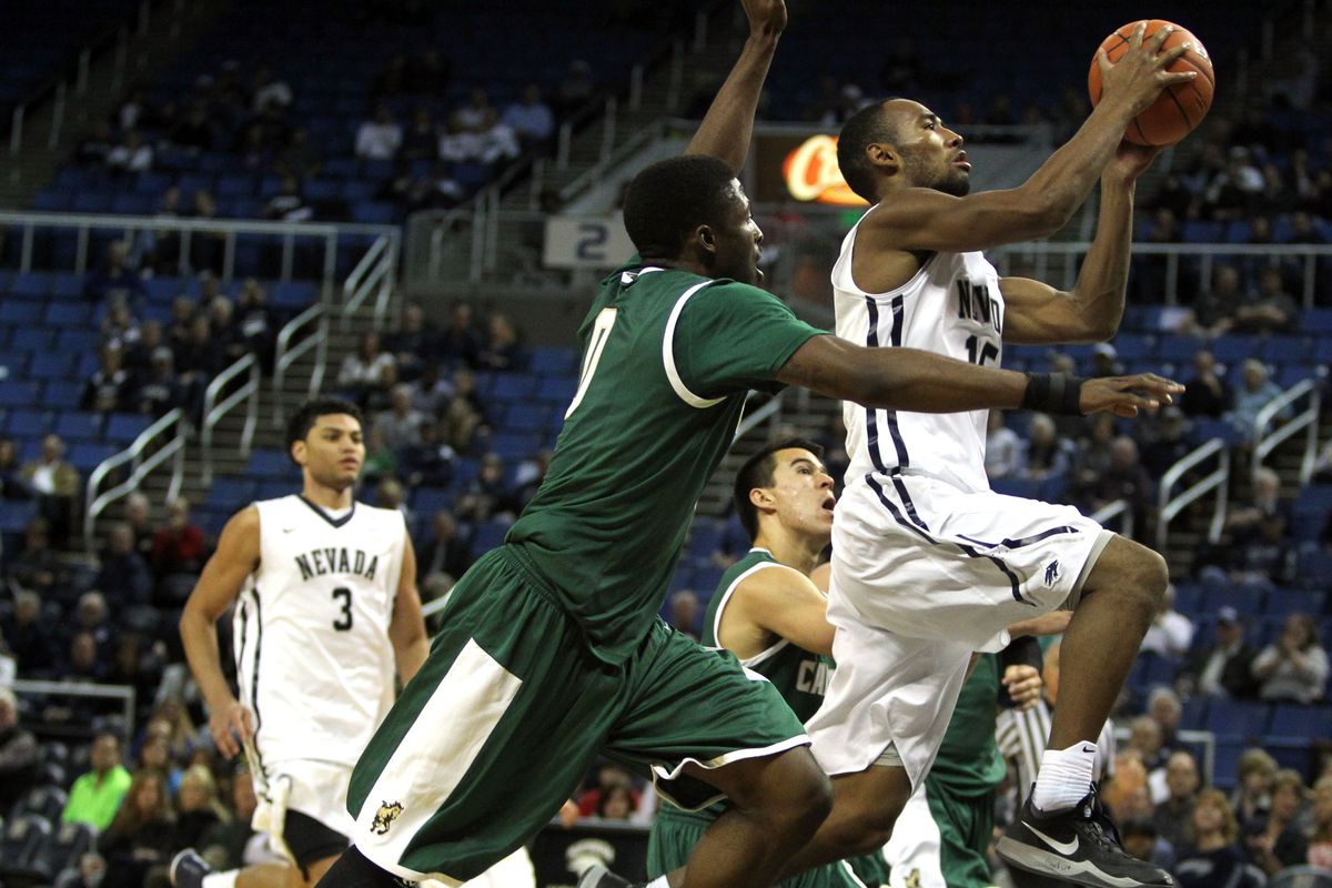 Nevada F DJ Fenner with the bucket on Cal Poly G David Nwaba in 65-49 win over Cal Poly.