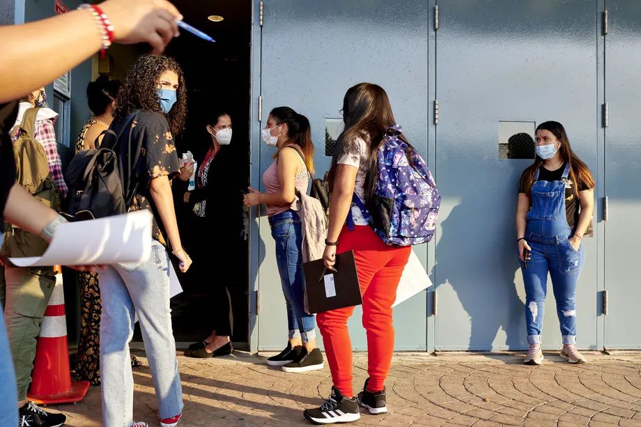 Students wait to enter their high school in Elmhurst Queens on Sept. 13, 2021. New York City is changing the competitive admissions criteria for high schools, but keeping certain geographic priorities based on a student’s home borough or zone.
