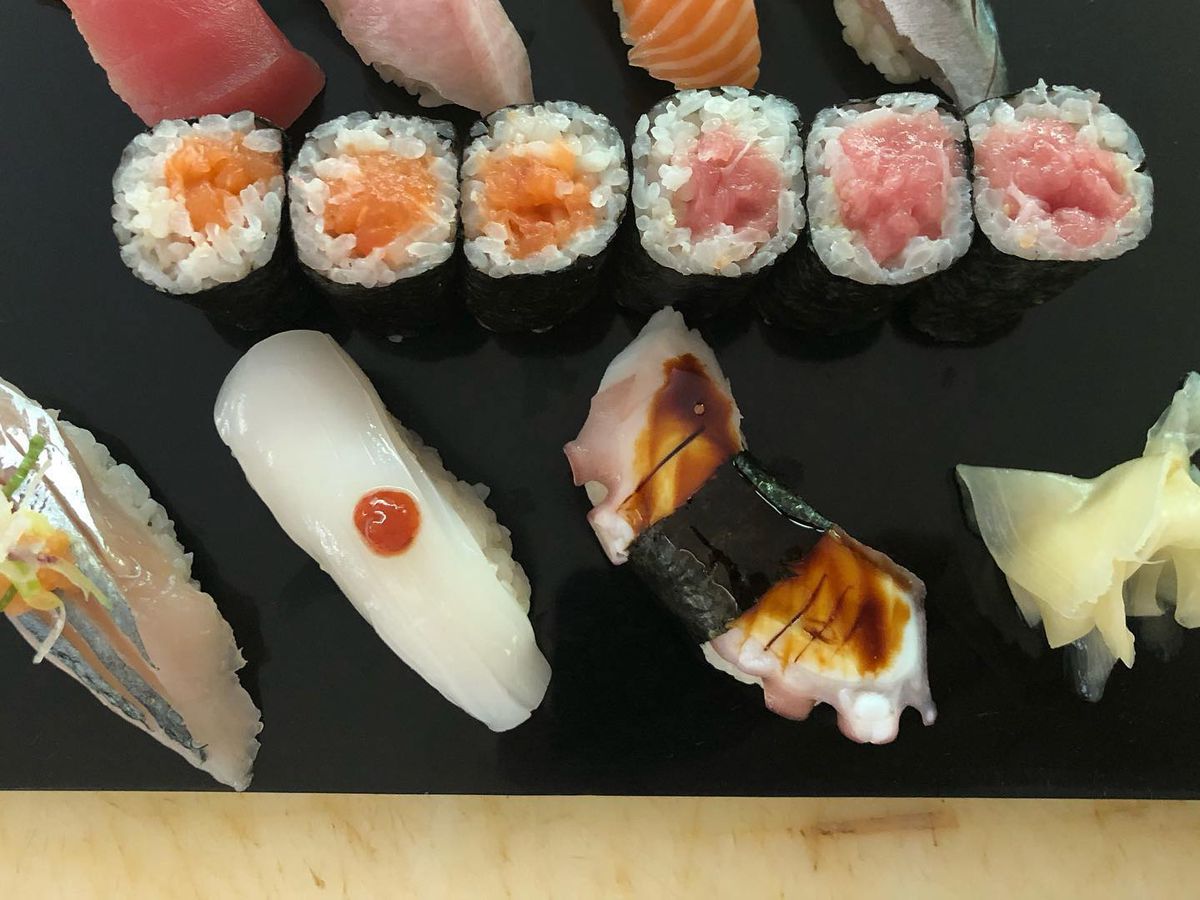 Maki and nigiri, pictured from above on a slate