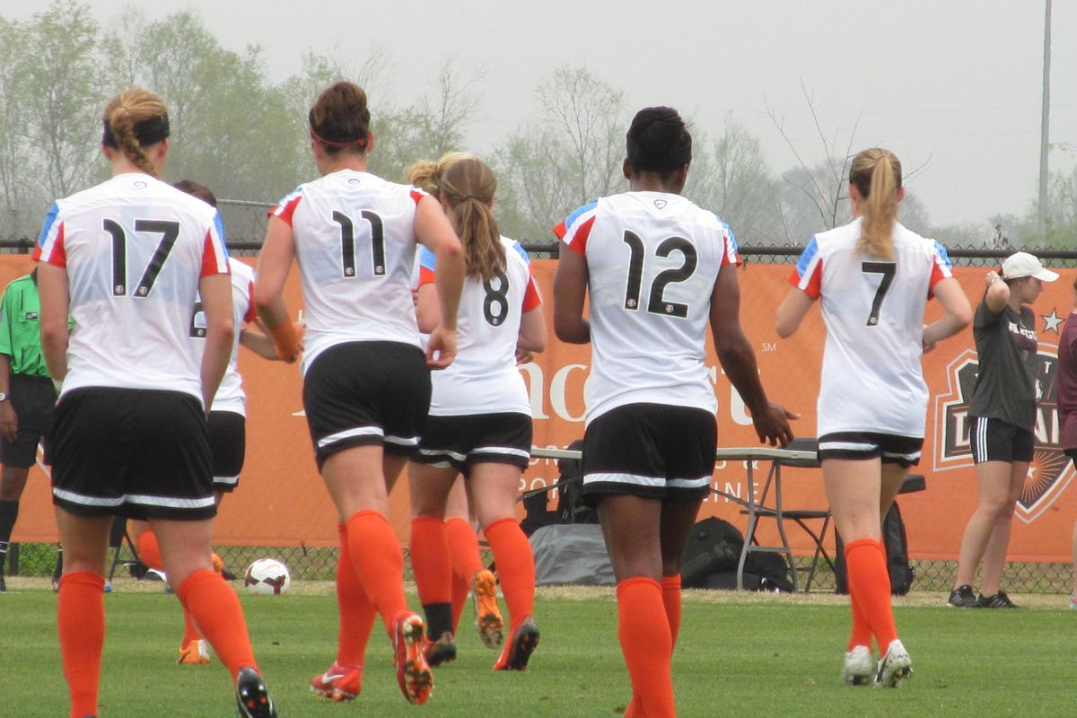 Houston Dash players walk off the pitch during a preseason match. 