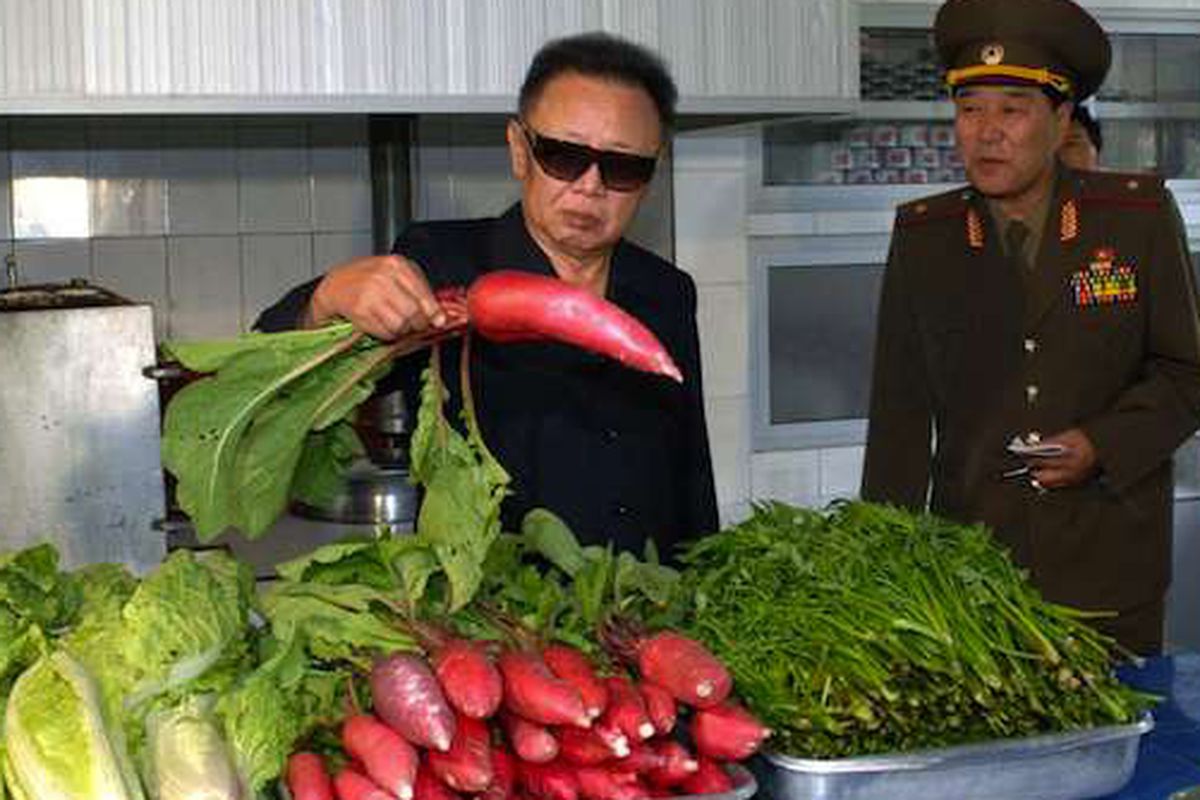 Kim Jong-Il hanging out with a giant radish. 
