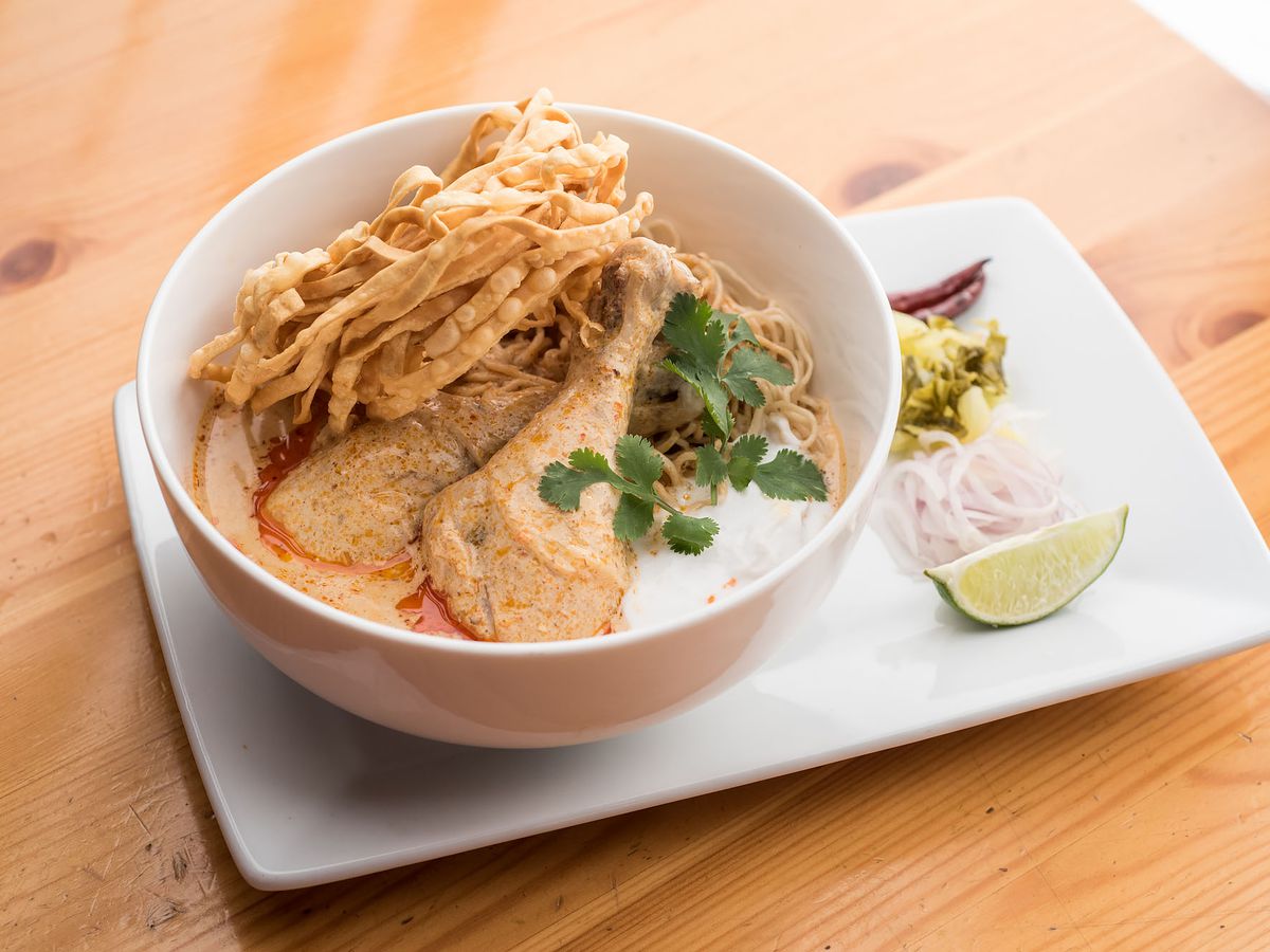 Khao soi at Ayara Thai, presented in a white bowl with lime wedge on the side.