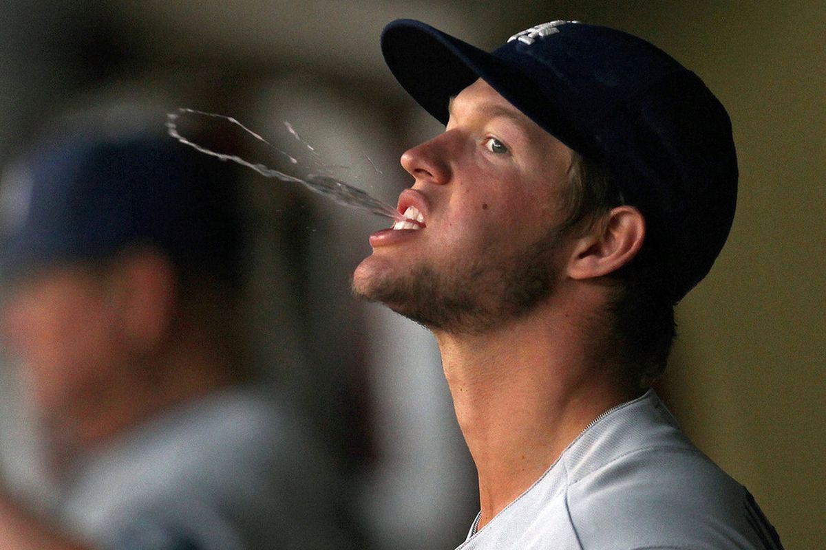 MIAMI GARDENS, FL - APRIL 25: Clayton Kershaw #22 of the Los Angeles Dodgers spits in the dugout during a game against the Florida Marlins at Sun Life Stadium on April 25, 2011 in Miami Gardens, Florida.  (Photo by Mike Ehrmann/Getty Images)