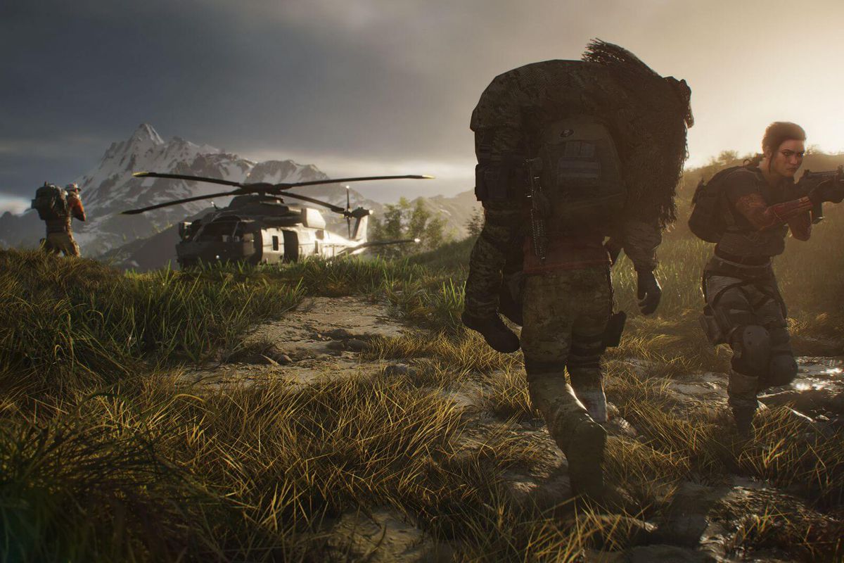 A soldier carries a wounded comrade in a ghillie suit back to a helicopter in Ghost Recon: Breakpoint