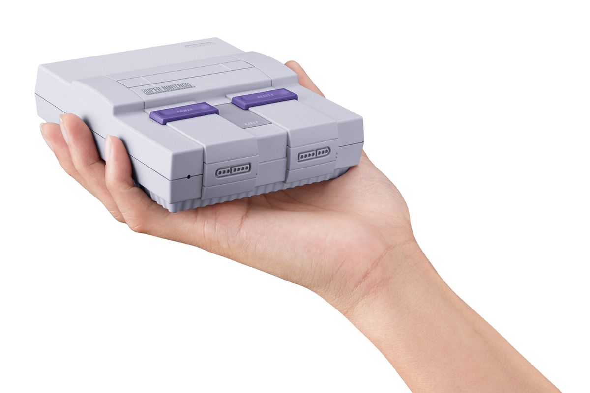 holding SNES Classic Edition in hand