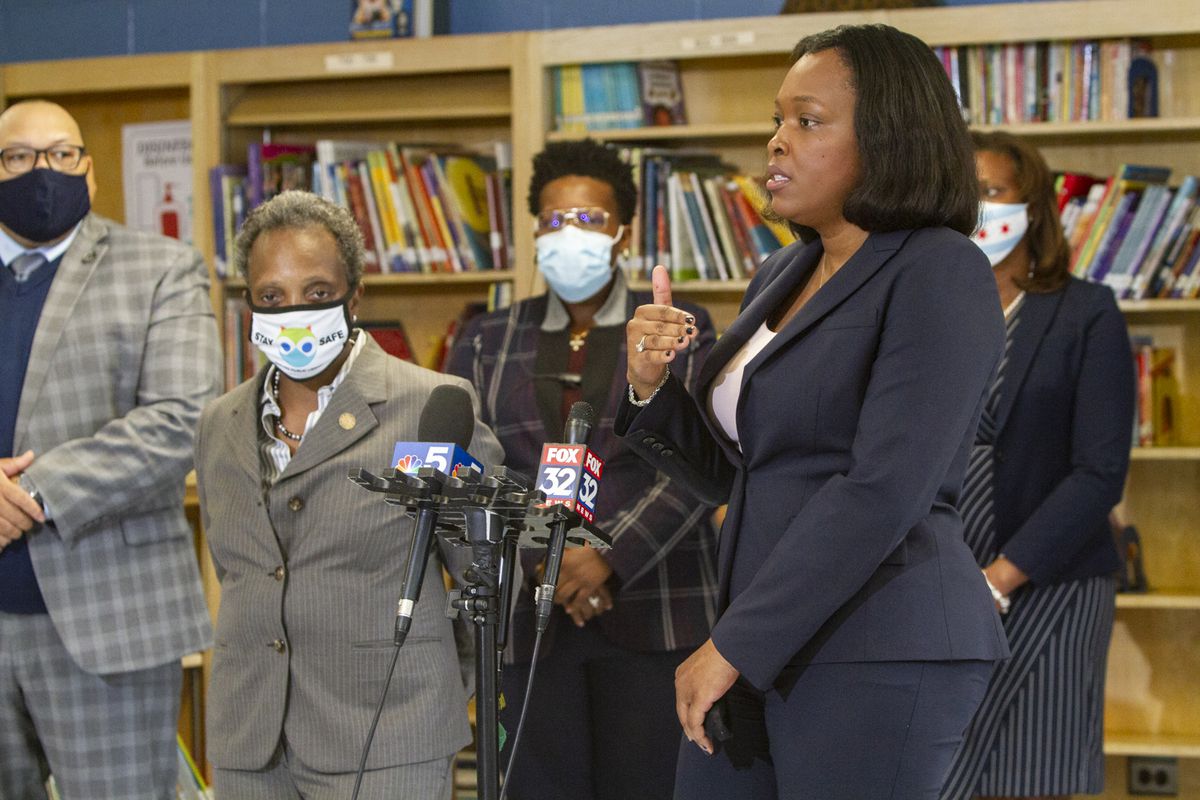 School chief Janice Jackson and Mayor Lori Lightfoot standing by microphones.