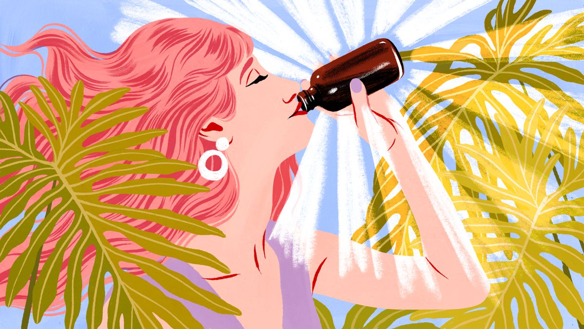 A woman with red hair drinks out of a brown bottle glowing with wellness