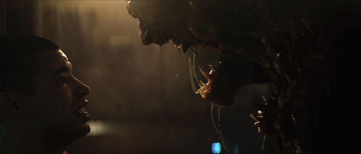 A prisoner faces a drooling monster in a still from The Callisto Protocol’s cinematic trailer