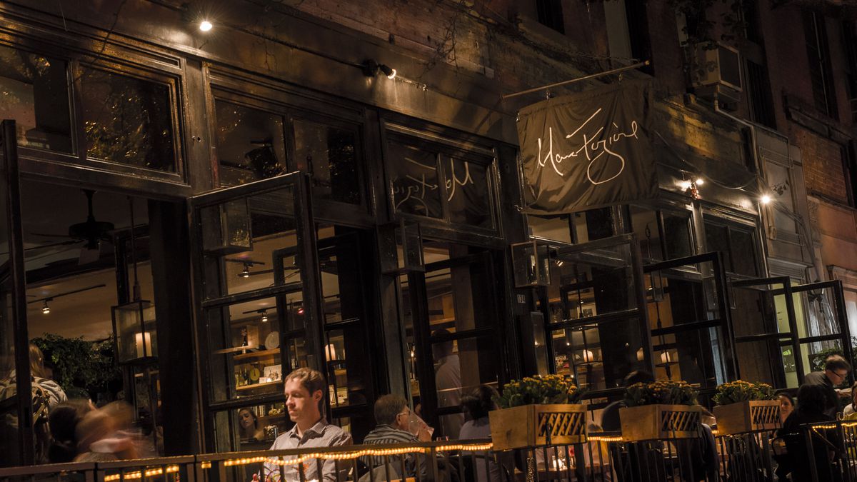 A man sits at an outside table at a Tribeca restaurant. 