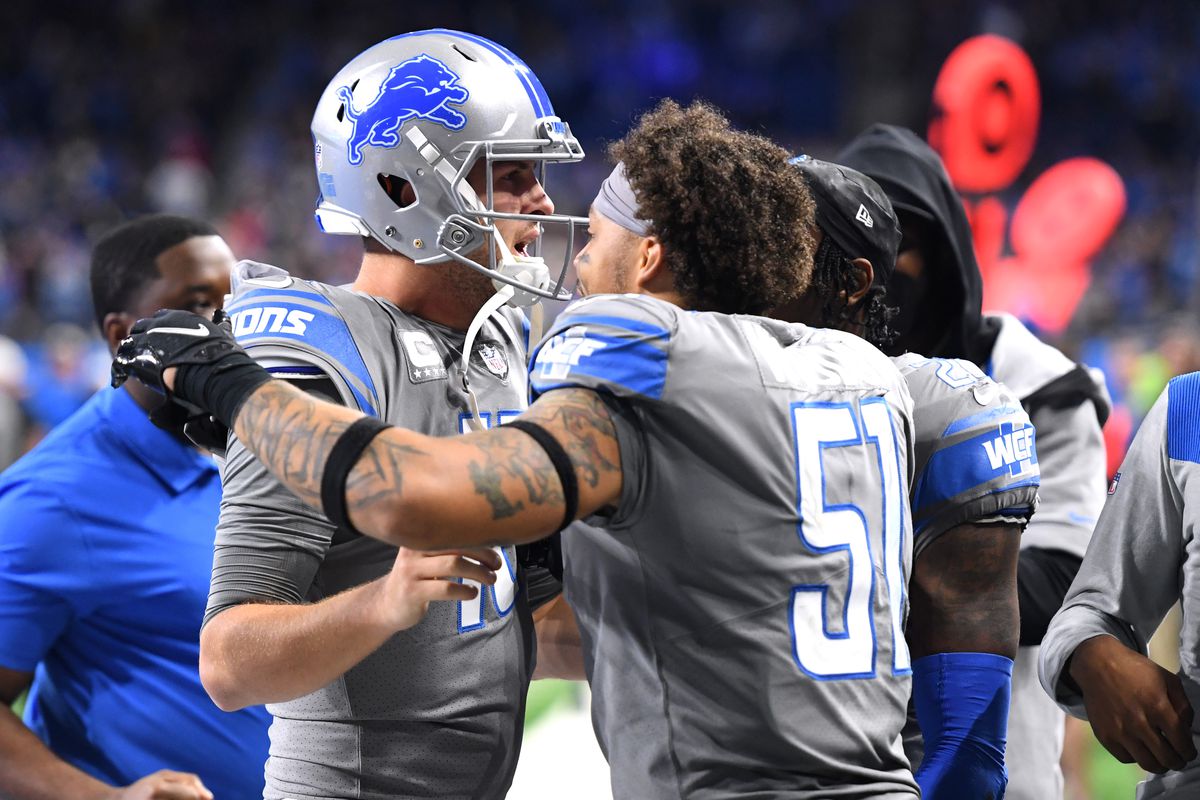 Jared Goff #16 of the Detroit Lions celebrates with Josh Woods #51 after throwing a touchdown pass as the time expired to defeat the Minnesota Vikings 29-27 at Ford Field on December 05, 2021 in Detroit, Michigan.