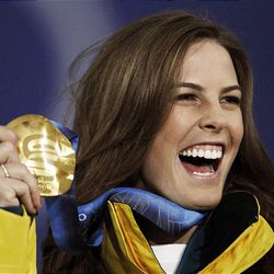 Torah Bright of Salt Lake City, competing for Australia, smiles with her gold medal after winning the women's snowboard halfpipe at the Vancouver 2010 Olympics in Vancouver, British Columbia, Friday.