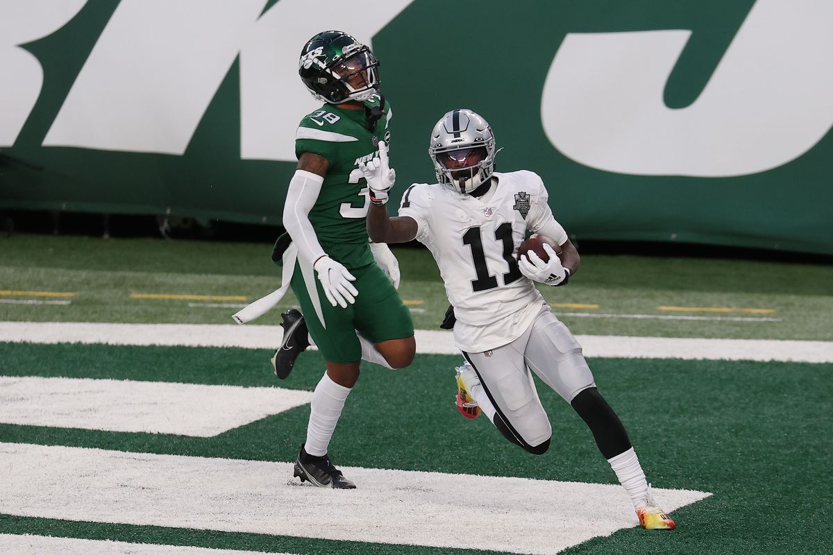 Henry Ruggs III #11 of the Las Vegas Raiders reacts after scoring a touchdown in the final seconds of the second half as Lamar Jackson #38 of the New York Jets looks on at MetLife Stadium on December 06, 2020 in East Rutherford, New Jersey.