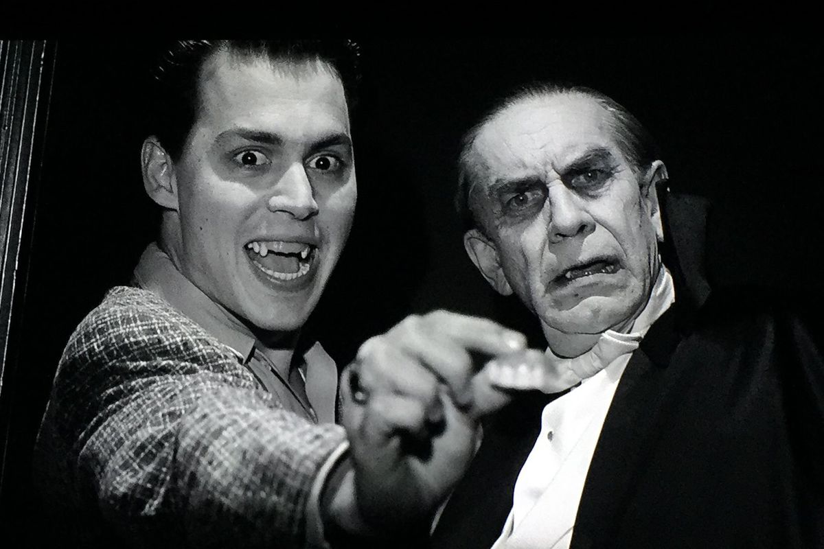Johnny Depp holding a pair of false teeth beside Martin Landau in a Dracula costume in 1994’s Ed Wood.