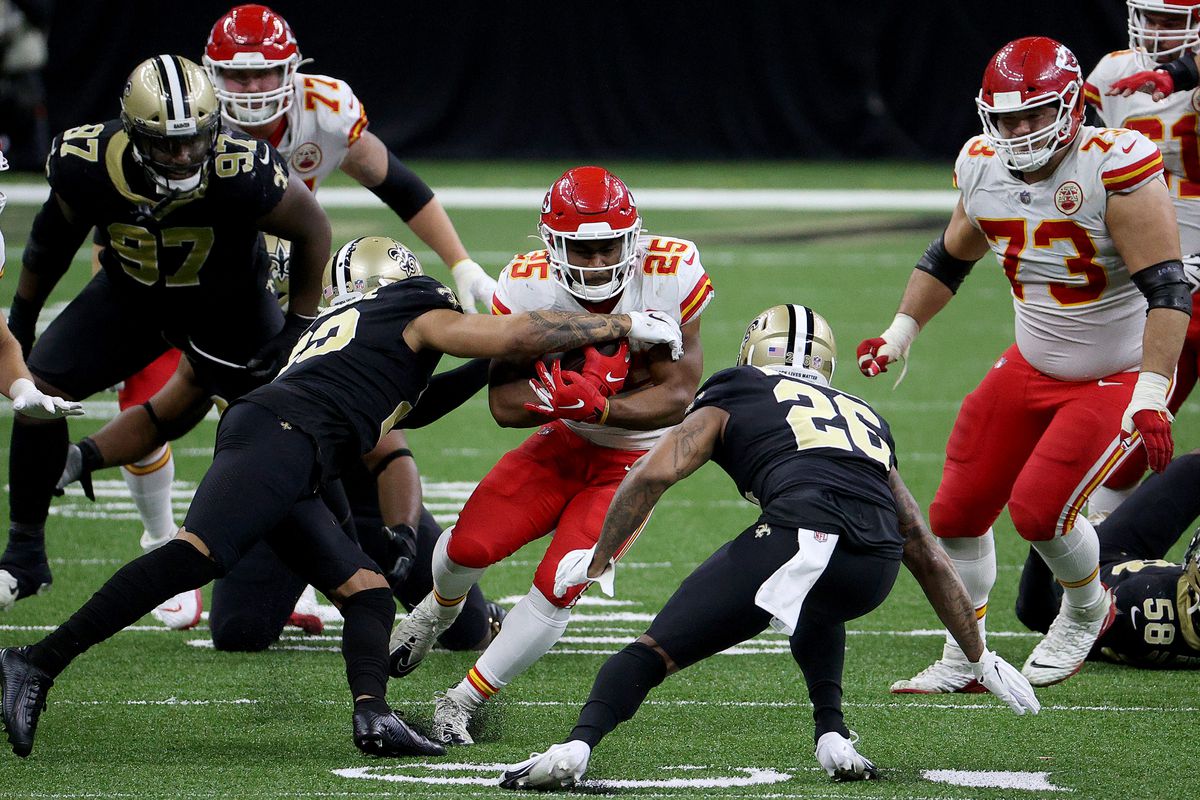 Clyde Edwards-Helaire #25 of the Kansas City Chiefs is stopped by Marshon Lattimore #23 of the New Orleans Saints during the fourth quarter in the game at Mercedes-Benz Superdome on December 20, 2020 in New Orleans, Louisiana.