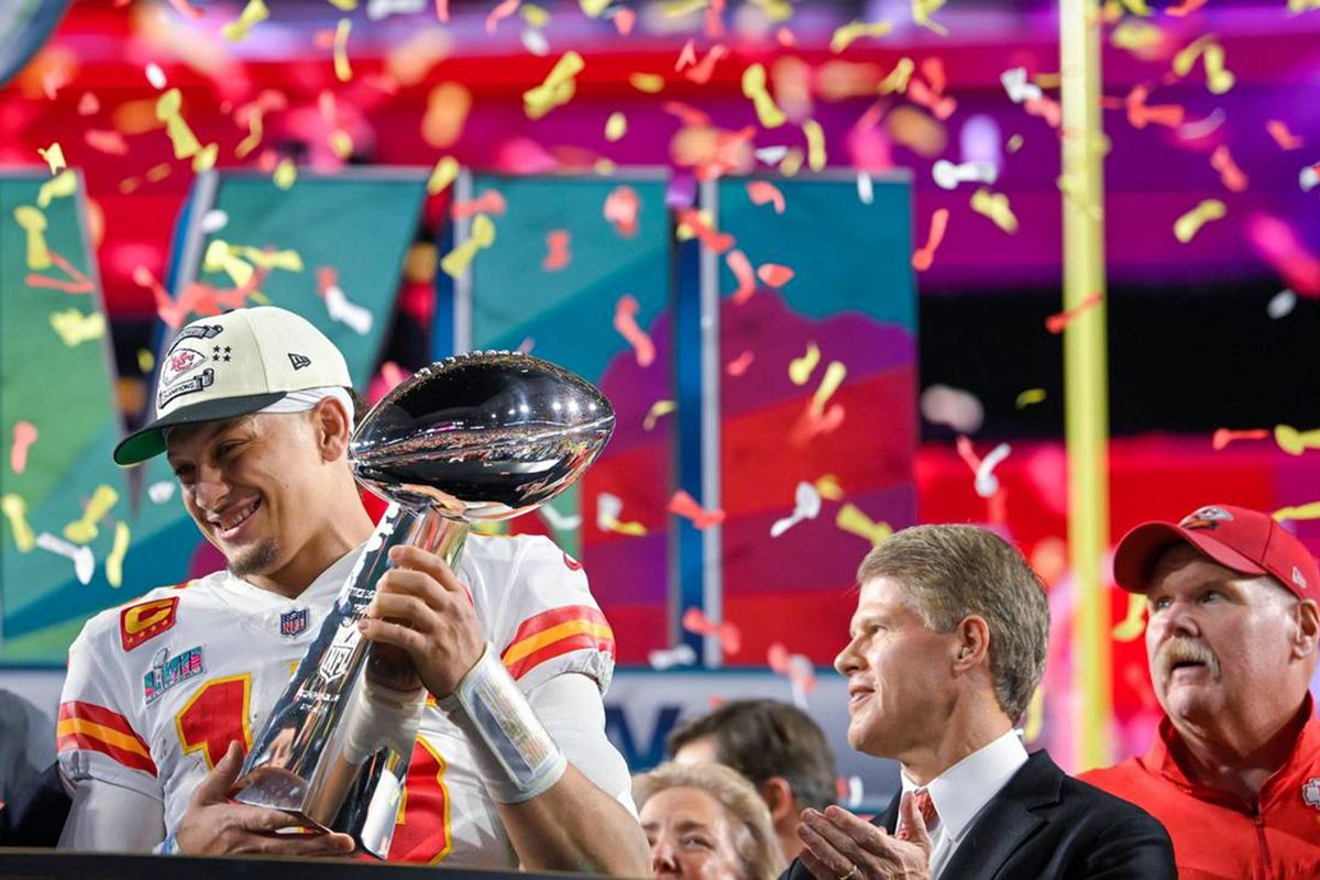 Kansas City Chiefs quarterback Patrick Mahomes (15) hoists the Lombardi Trophy after leading the Chiefs to a Super Bowl LVII victory, 38-35, over the Philadelphia Eagles on Sunday, Feb. 12, 2023, at State Farm Stadium in Glendale, Arizona. Chiefs Chairman &amp;amp; CEO Clark Hunt and head coach Andy Reid look on.