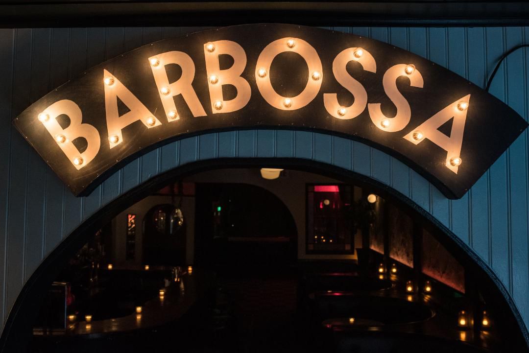 A lit-up sign reading “Barbossa”.