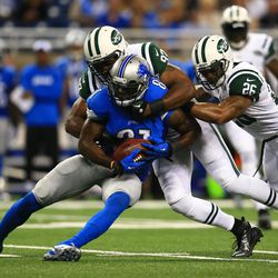 Aug 9, 2013; Detroit, MI, USA;Detroit Lions wide receiver Calvin Johnson (81) makes a catch and is tackled by the New York Jets defense in the first quarter of a preseason game at Ford Field.