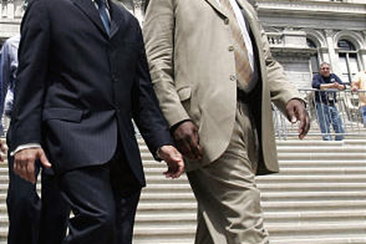 New York Gov. David Paterson, left, and aide David Johnson walk down the New York Capitol steps in 2008.