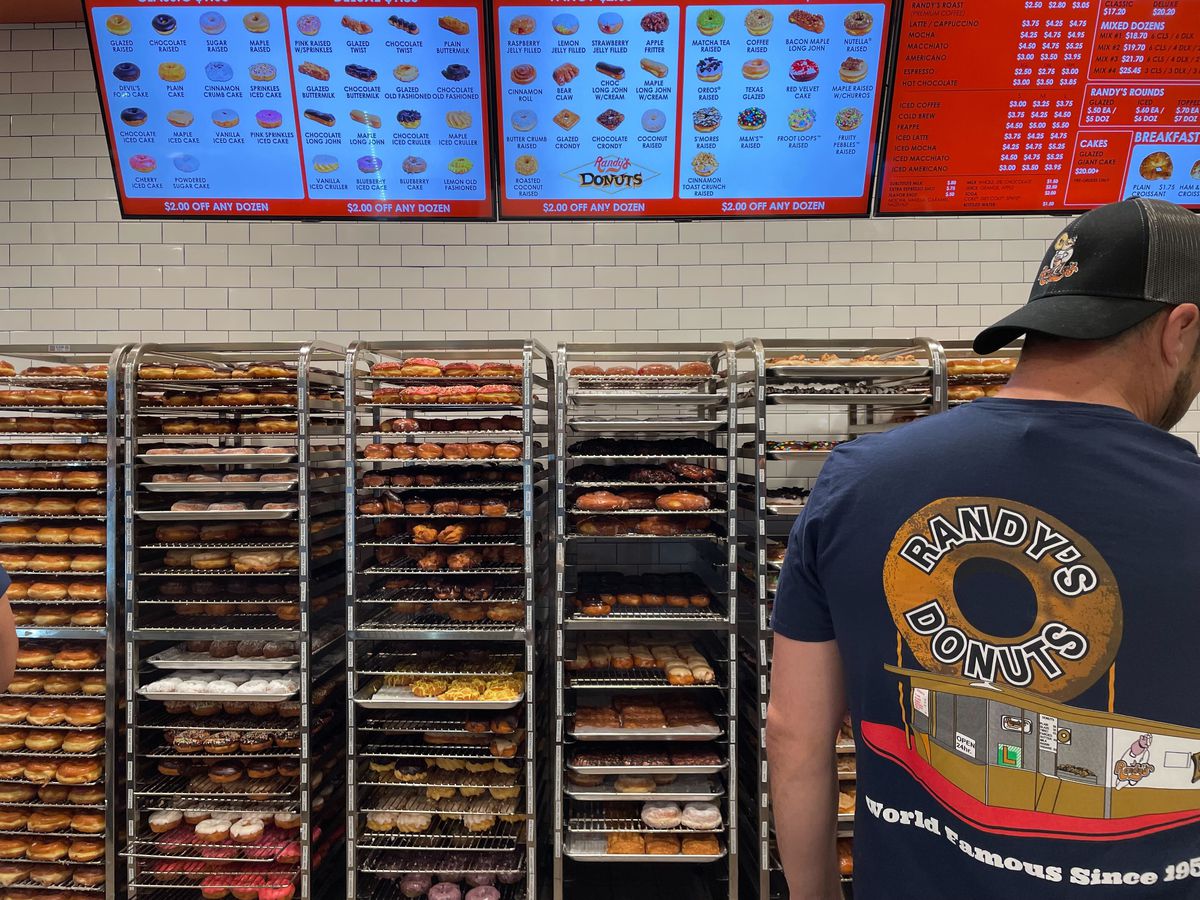 A man wearing a “Randy’s Donuts” shirt