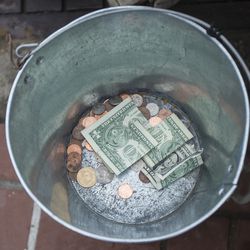 A money bucket belonging to Fred Rivers, a homeless man originally from Bristol, Vermont, and now living in downtown Salt Lake City near Vivint Smart Home Arena on Monday, Feb. 26, 2018. Rivers said he tries to get enough money for him and his dog, Lucy, to get a hotel room, but he said it’s hard with a dog because people want to charge extra money for a pet to come to the hotel. “A lot of times we just sleep outside,” he said.