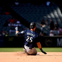 ANAHEIM, CALIFORNIA - SEPTEMBER 18: Dylan Moore #25 of the Seattle Mariners slides safely into second in the eighth inning during a game against the Los Angeles Angels of Anaheim at Angel Stadium of Anaheim on September 18, 2022 in Anaheim, California.