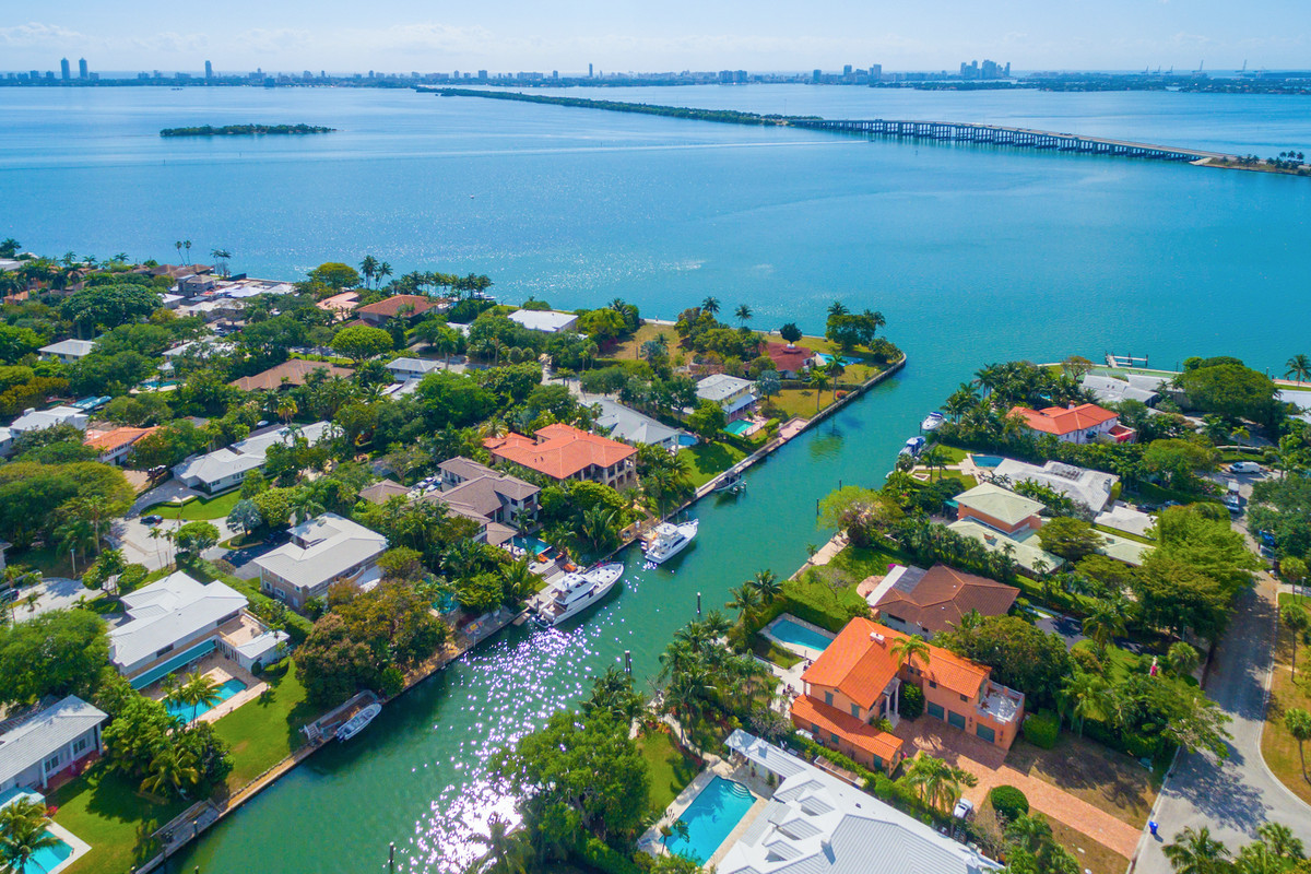 Aerial of homes on the water in a fancy Miami community on the bay.