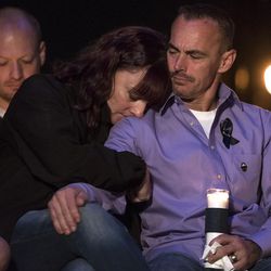 Jenny and Jeff Brotherson, the parents of fallen West Valley City police officer Cody Brotherson, embrace each other during a vigil for their son in West Valley City on Wednesday, Nov. 9, 2016. Brotherson, 25, was hit while trying to lay tire spikes at the intersection of 4100 South and 2200 West to help other officers stop a fleeing stolen vehicle.